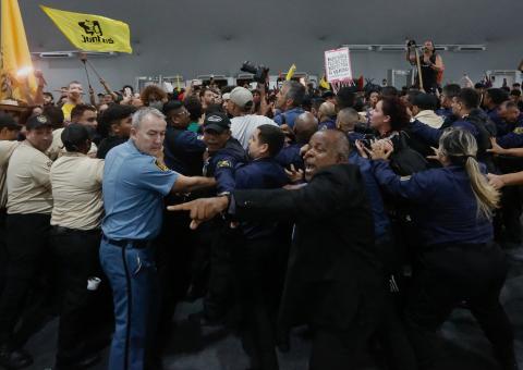 Security personnel clash with indigenous people and students as they storm the venue during the COP30 